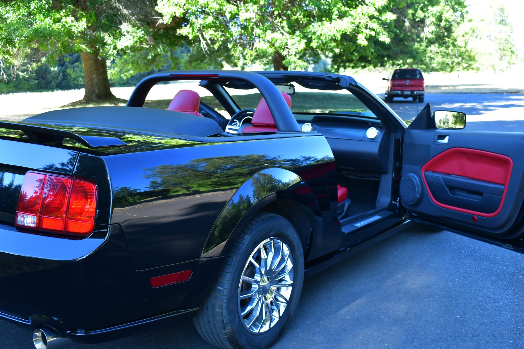 Rear close-up showing chrome wheel and dual exhaust